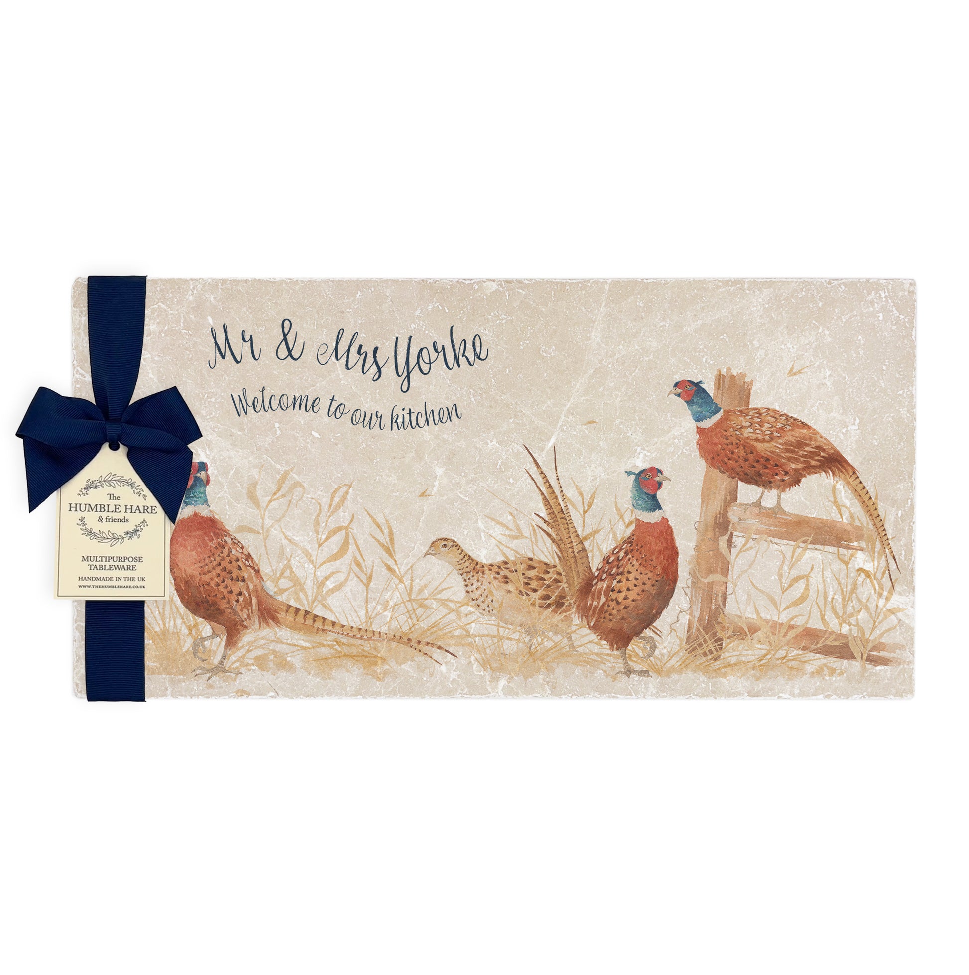 A personalised rectangular marble sharing platter featuring a parade of pheasants in a watercolour style,  packaged with a luxurious dark blue bow and branded gift tag.