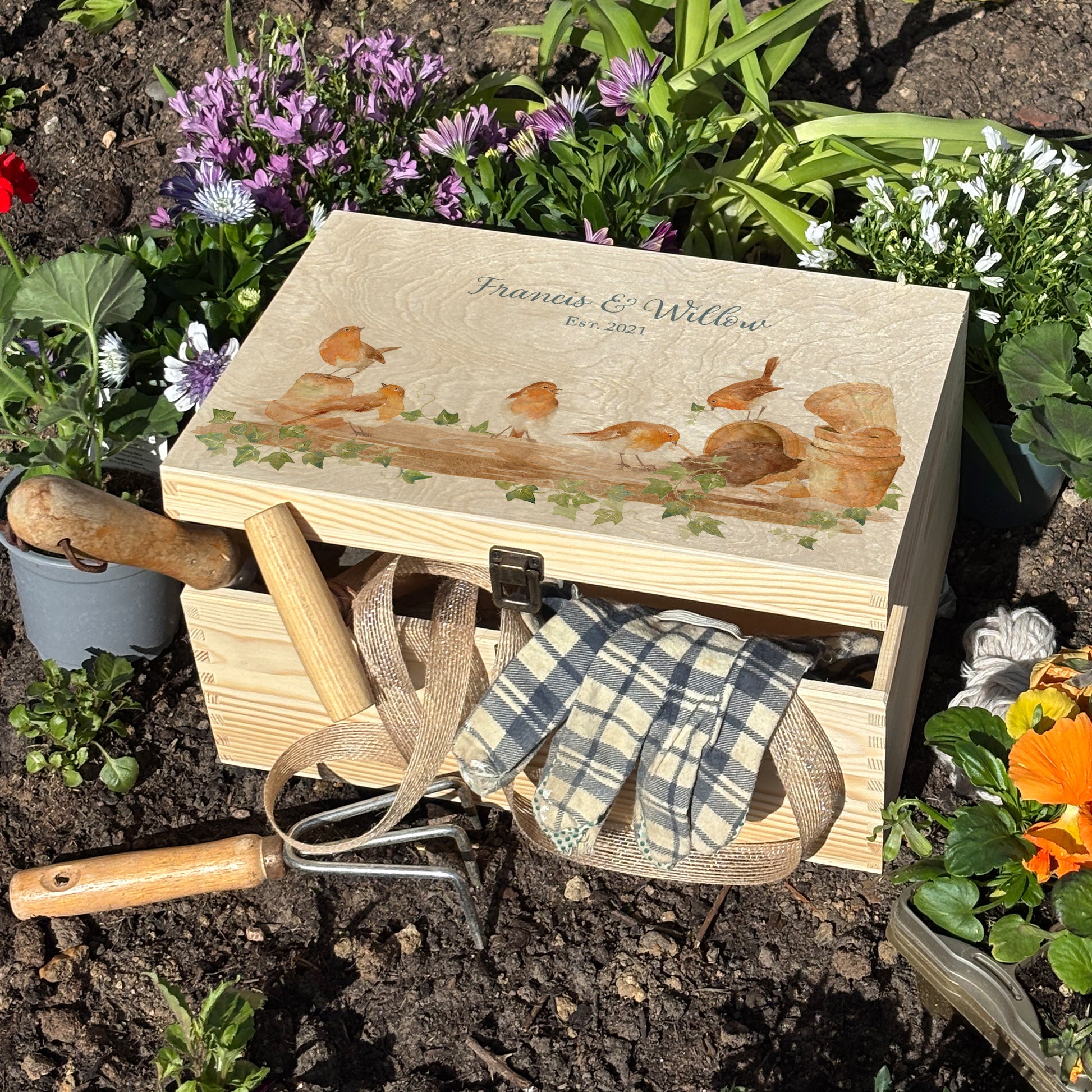 Large wooden pine gift box, The perfect Personalised keepsake, memory box, storage box with a rabble of robins playing on a greenhouse shelf covered in Ivy and plant pots, some of the robins have knocked over the plant pots leaving soil on the self.  The design  features our classic gentle watercolour style. great unique storage box. Garden tool storage, trinkets and special memories stored in one place. Easy stackers