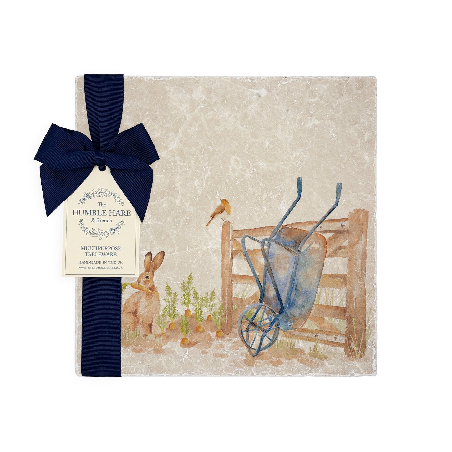 A medium multipurpose marble platter with a watercolour vegetable patch design, packaged with a luxurious dark blue bow and branded gift tag.