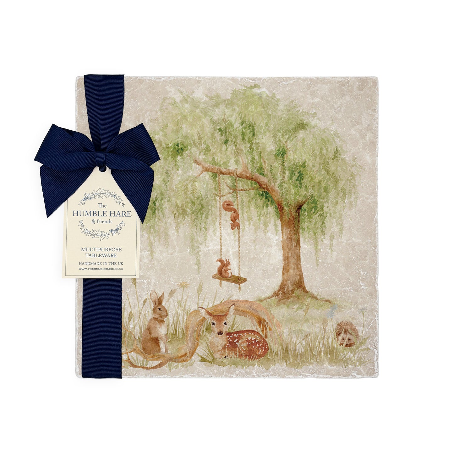 A medium multipurpose marble platter with a watercolour scene of woodland animals under a willow tree, packaged with a luxurious dark blue bow and branded gift tag.