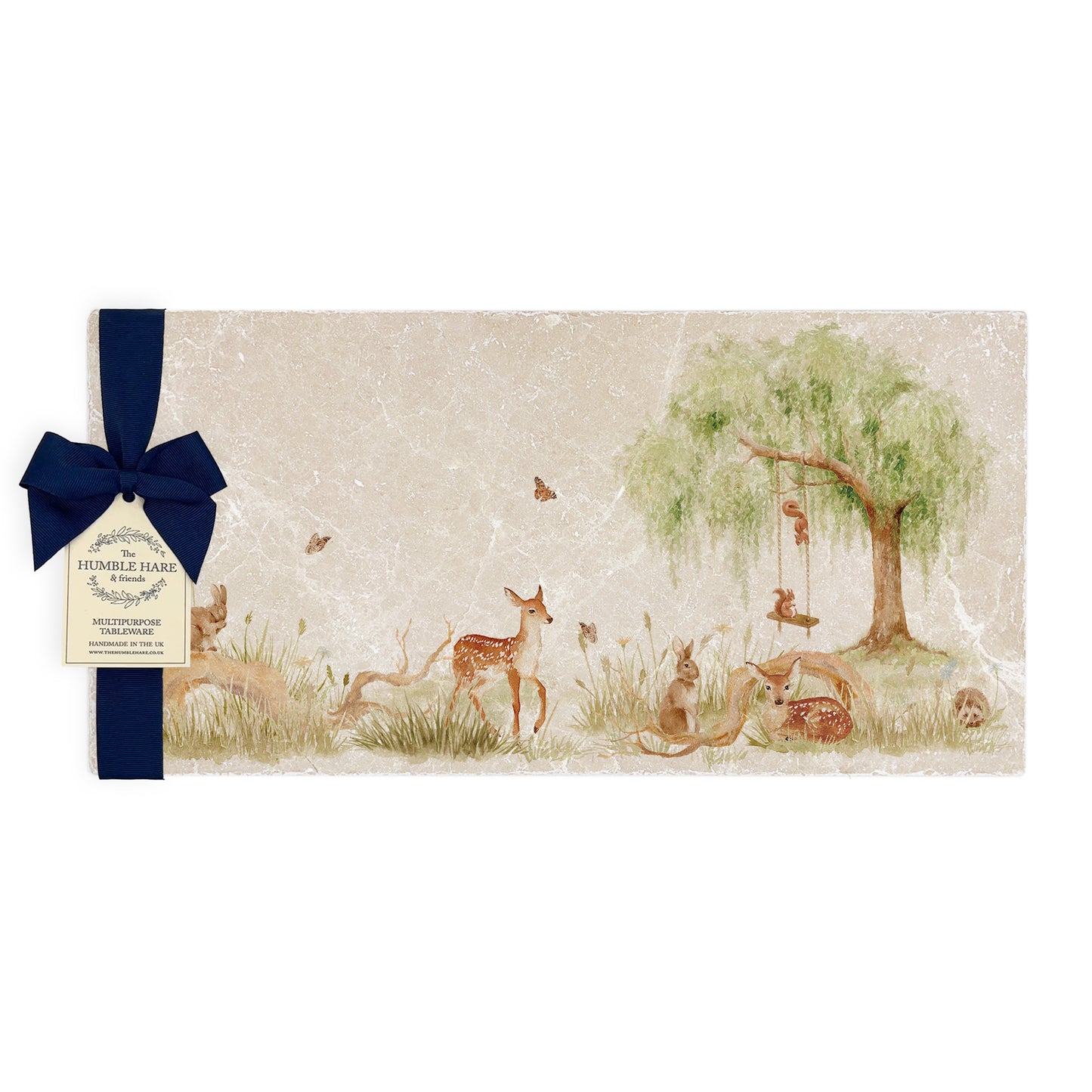A multipurpose marble sharing platter with a watercolour scene of woodland animals under a willow tree, packaged with a luxurious dark blue bow and branded gift tag.