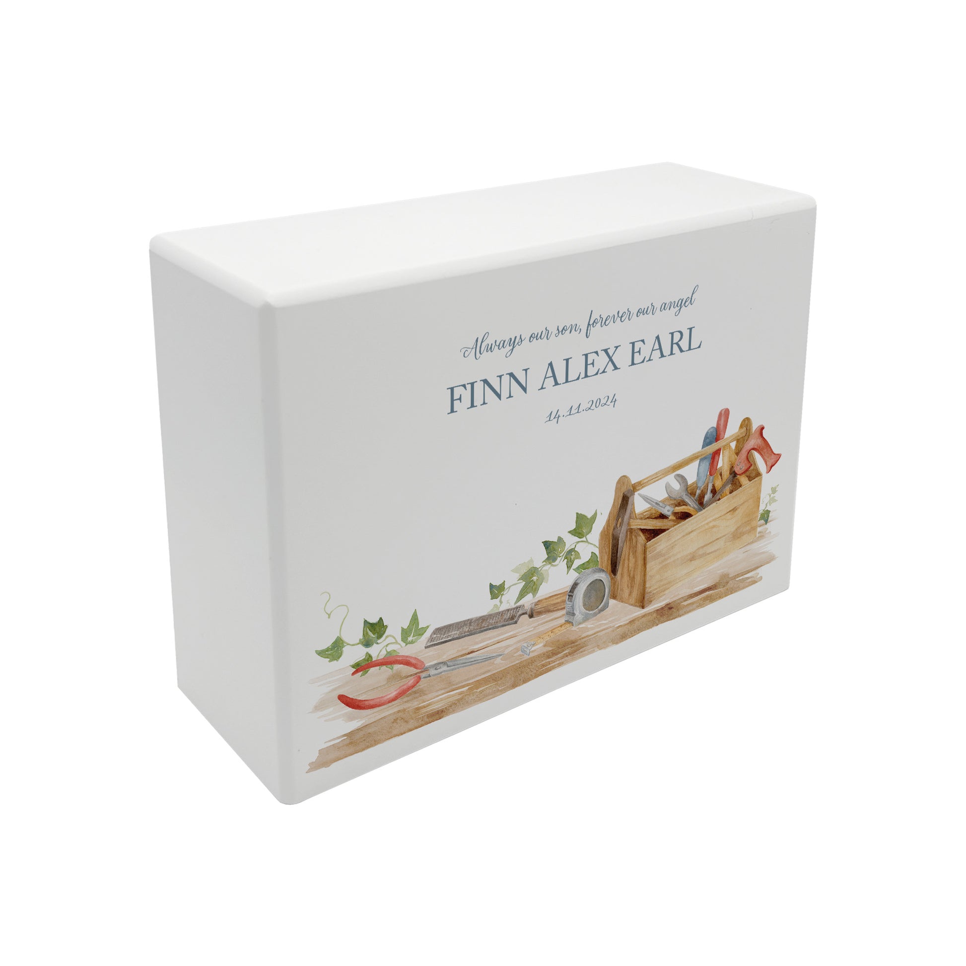 A beautifully crafted solid wooden urn, finished in white with a soft watercolour design of a Tool box on a shelf, perfect for Dad, brother, uncle, Grandad who loved his workshop. Thoughtfully made for either display or burial, this personalised urn can be customised to create a meaningful memorial. Perfect for holding ashes of a loved one or a beloved pet, it serves as a comforting tribute and keepsake.
