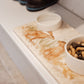 A rectangle marble platter with pet food and water bowls on it. The marble platter has a watercolour design featuring two hares facing each other about to touch noses.