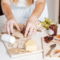 A marble sharing platter with a watercolour British garden birds design being used as a cheeseboard.