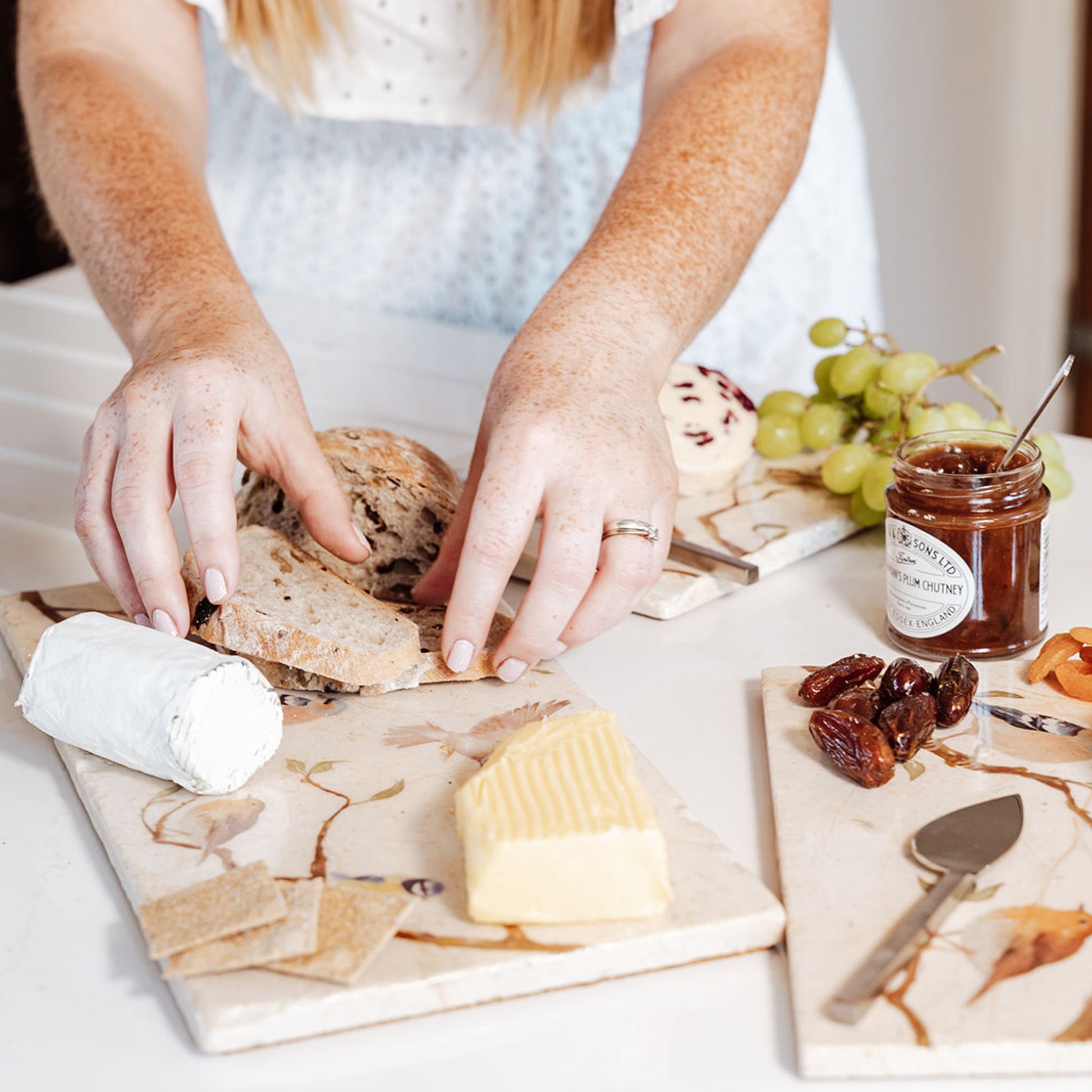 A marble sharing platter with a watercolour British garden birds design being used as a cheeseboard.