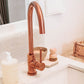 A tiled splashback behind a bathroom sink. The splashback is made up of large rectangular cream marble tiles.