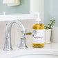 A tiled splashback behind a bathroom sink. The splashback is made up of medium plain cream marble tiles.