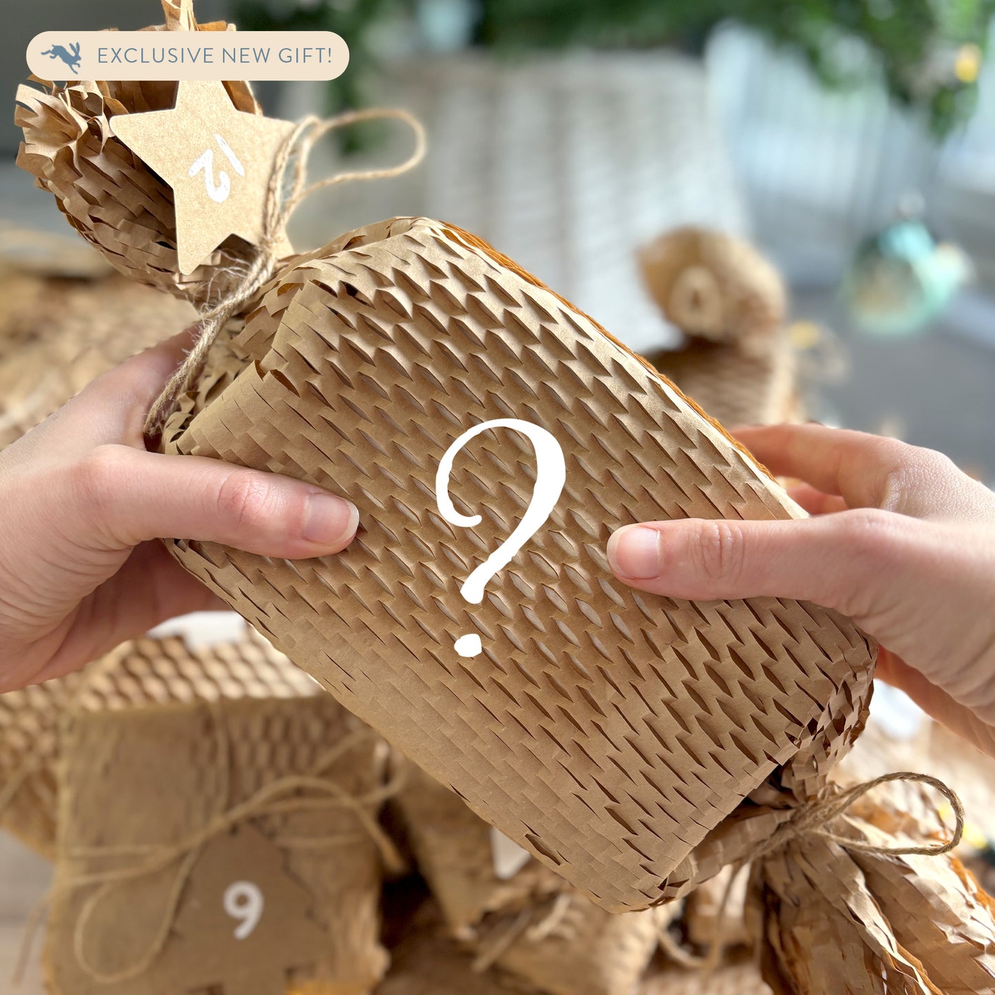 A mystery gift in a 12 Days of Christmas advent calendar, the gift is wrapped in brown paper and tied with string and a numbered label. The gift is a brand new product and mystery gift.
