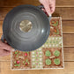 A marble Ludo board with an allotment theme, that doubles as a trivet for hot pots and pans.