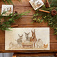 A rectangular marble sharing platter featuring a nativity scene with donkeys, sheep, a chicken, and a lamb in a manger,