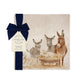 A square marble platter featuring a Nativity scene illustration with three donkeys, a sheep, and a lamb in a manger, wrapped with a dark blue ribbon and bow. 