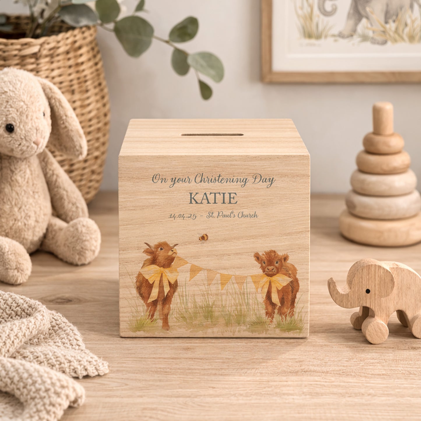 personalised watercolour money box handmade for christening keepsake, sweet highland cow babies playing in a field with bunting with bows around their necks