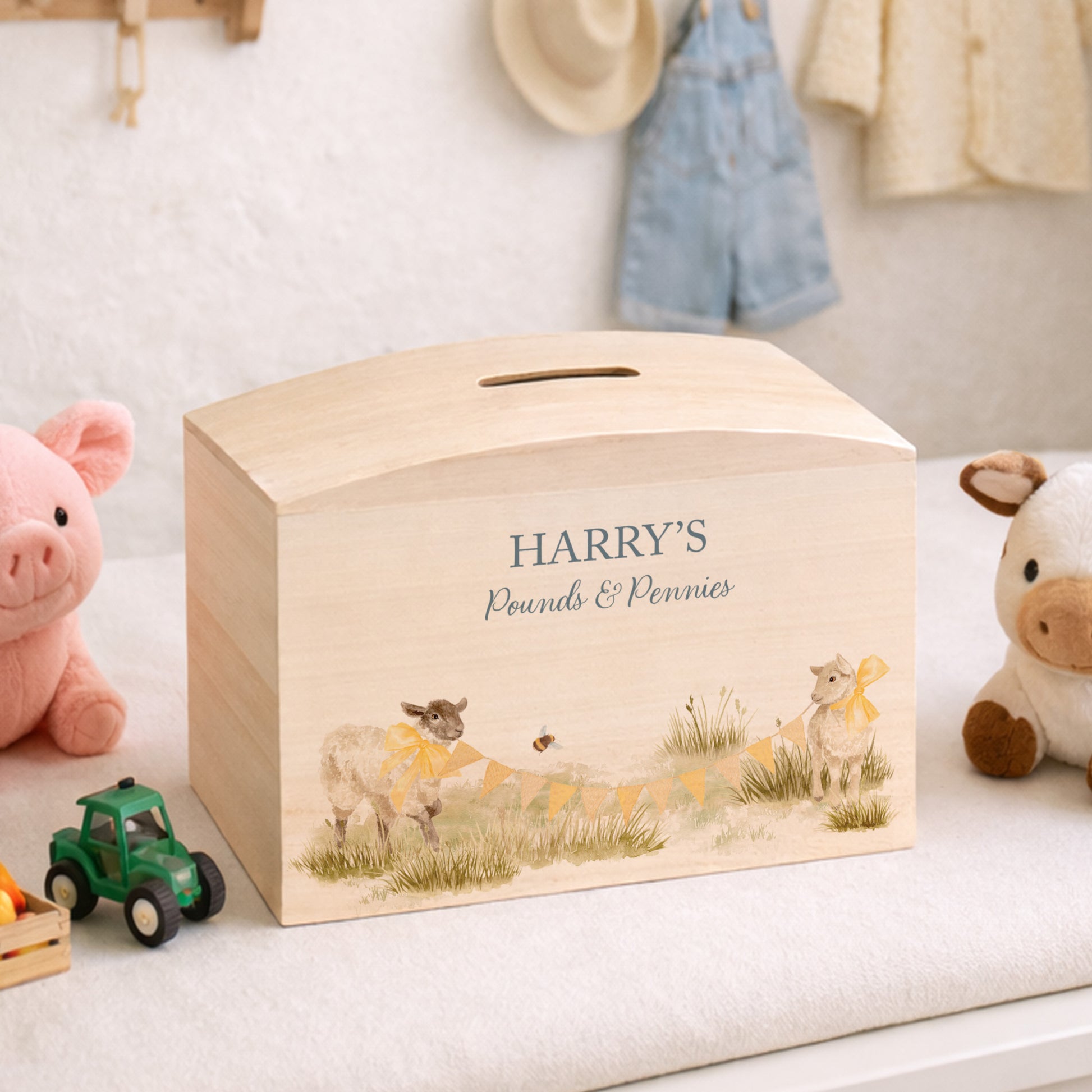 Baby Lambs playing with Bunting with bows on them, choice of Blue, Pink and yellow colour, the perfect money box for your little savers. Newborn, birthday and christening gift. 