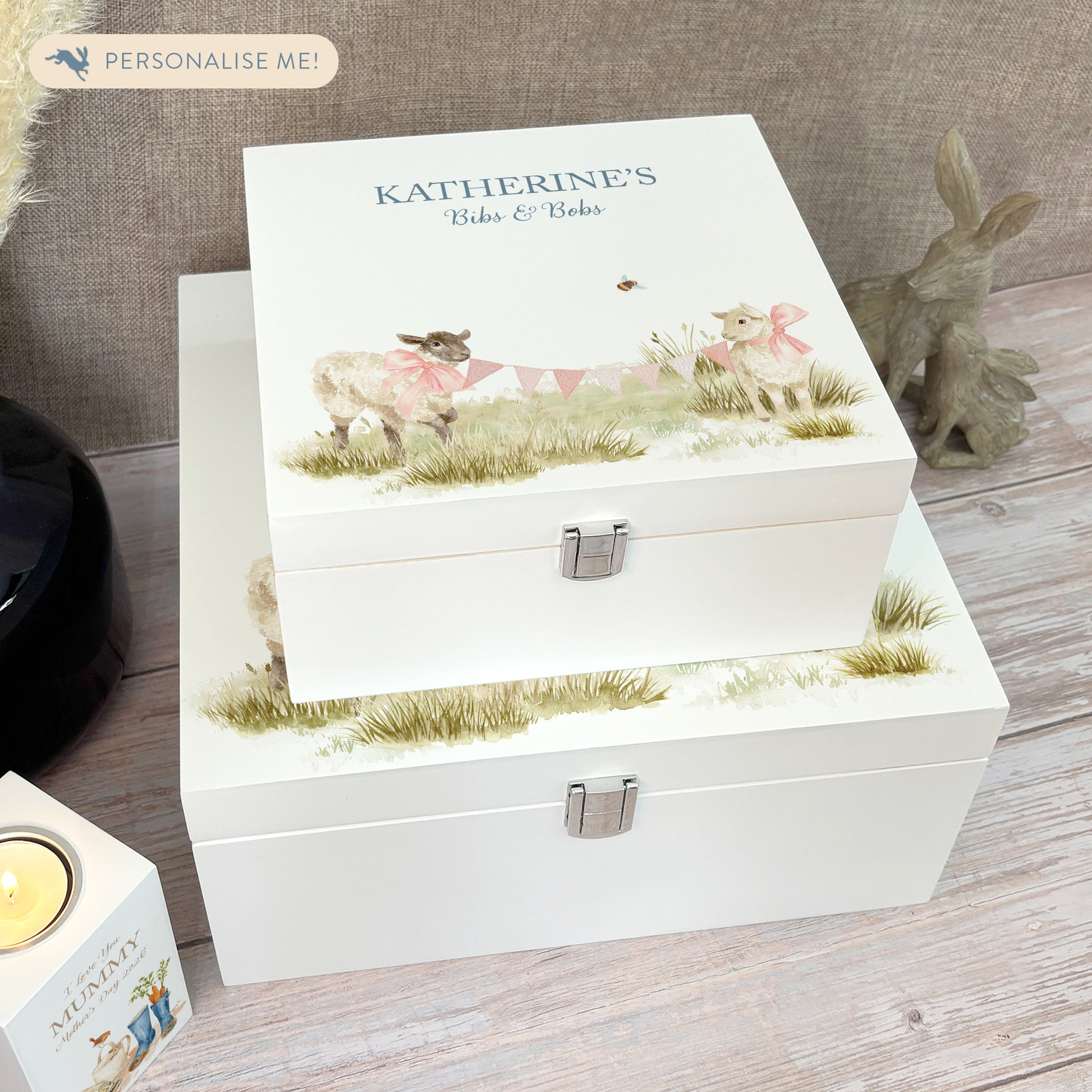 A white wooden keepsake box featuring a sweet baby lambs design, personalised with custom text. Choose from two sizes, medium and large.