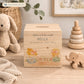 personalised handmade wooden money box styled in a cosy childrens bedroom, sweet chicks sat on speckled eggs playing with bunting with bows around their necks