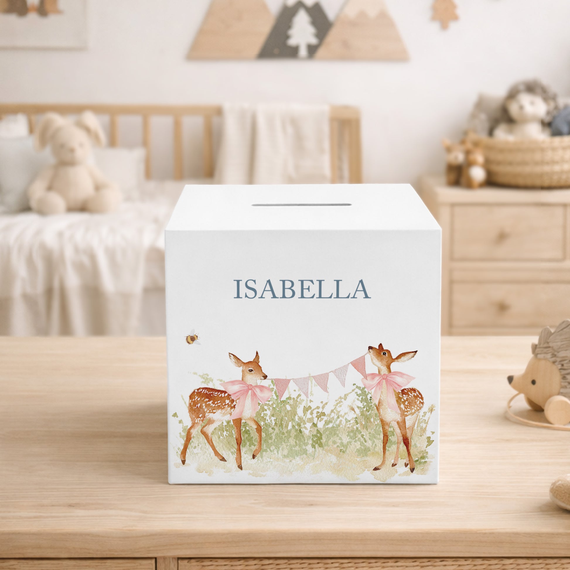 handmade nursery décor money box with delicate watercolour fawn artwork holding bunting and wearing bows