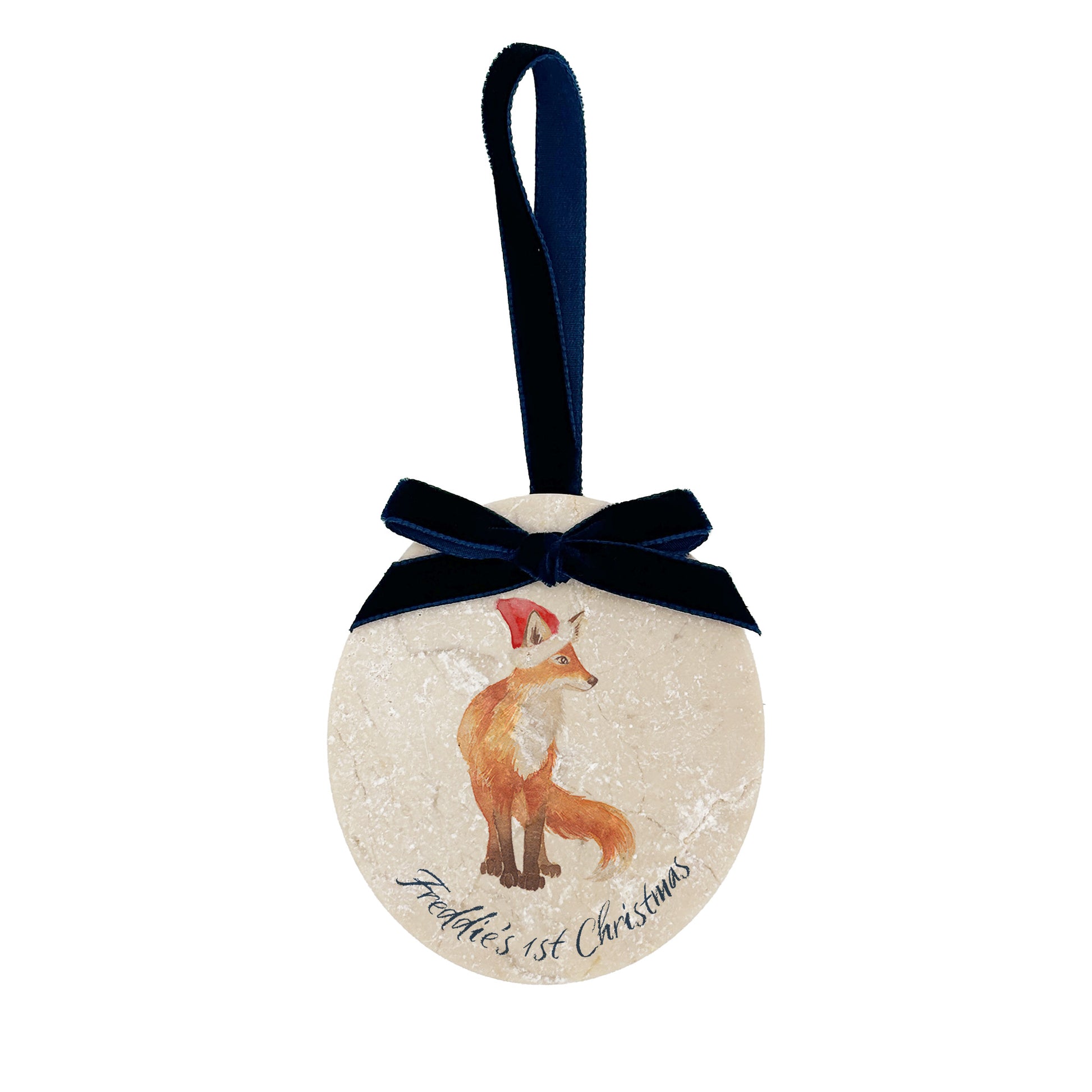 An oval marble bauble featuring a watercolour baby fox cub, with personalised text to celebrate baby's first Christmas, and the option to add a Santa hat. The bauble is finished with a velvet ribbon.