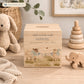 wooden handmade baby money box styled in a neutral childrens bedroom, cute lambs playing with bunting and bows around their necks