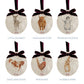 Six oval marble Christmas baubles showing the different design choices customers can choose from for their set. All of the baubles feature watercolour illustrations of countryside animals, and are finished with a luxurious velvet bow and hanging loop.