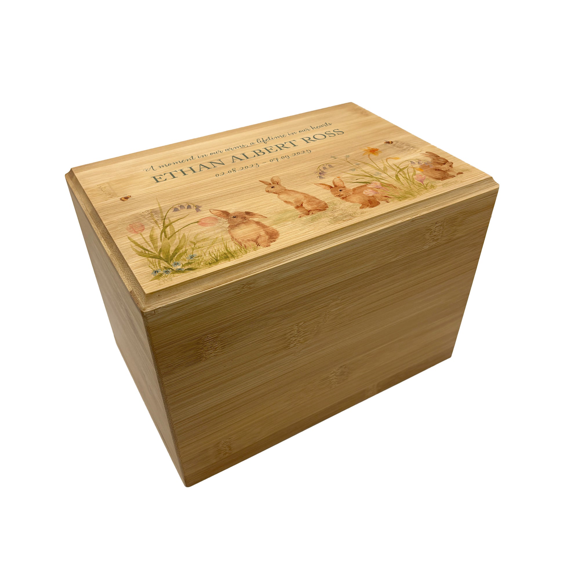 A beautifully crafted solid Bamboo wooden urn, finished with a soft watercolour design of bunnies in a spring flower meadow, Thoughtfully made for either display or burial, this personalised urn can be customised to create a meaningful memorial. Perfect for holding ashes of a loved one or a beloved pet, it serves as a comforting tribute and keepsake. 