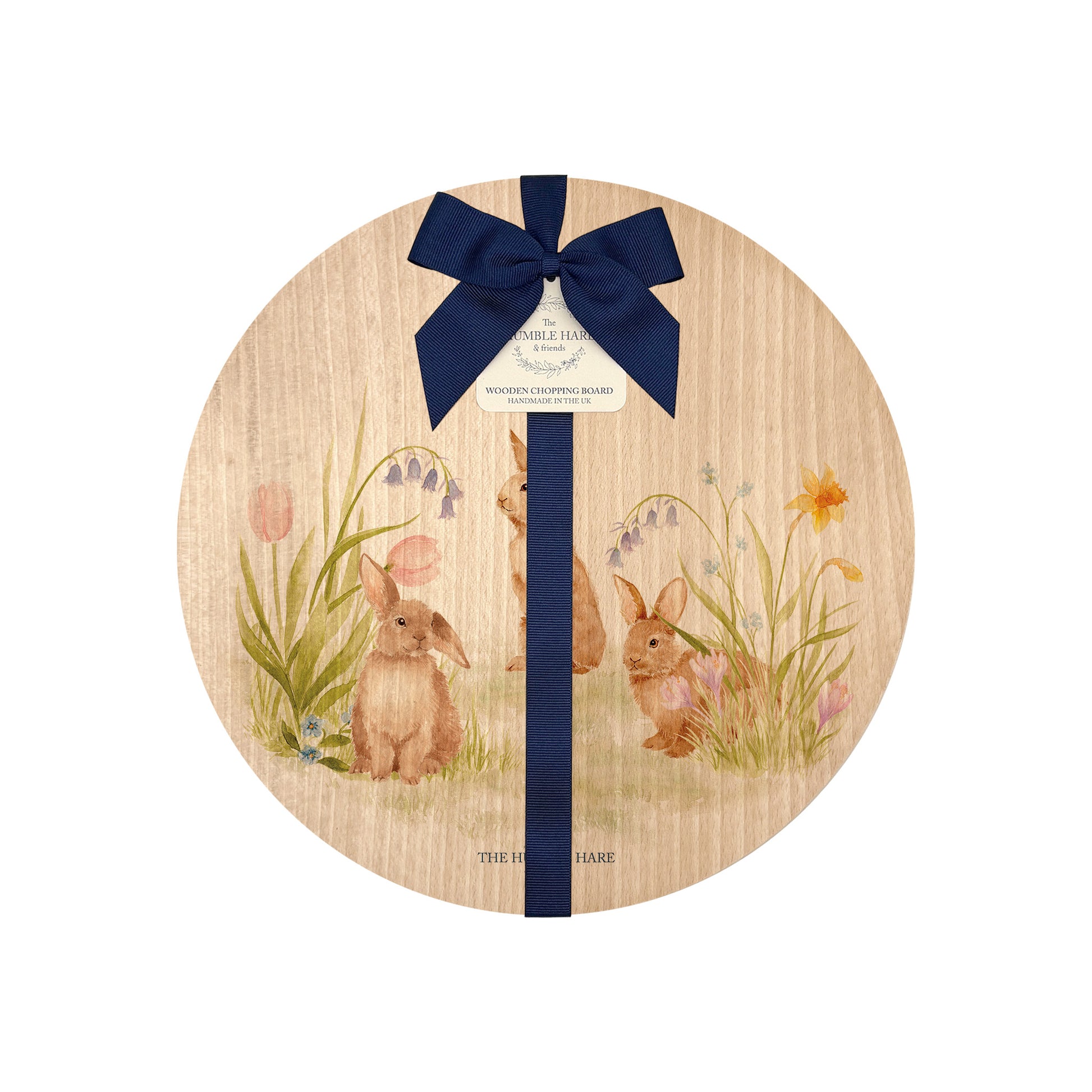 Round wooden board with rabbit and flower design, tied with a blue ribbon and gift tag.
