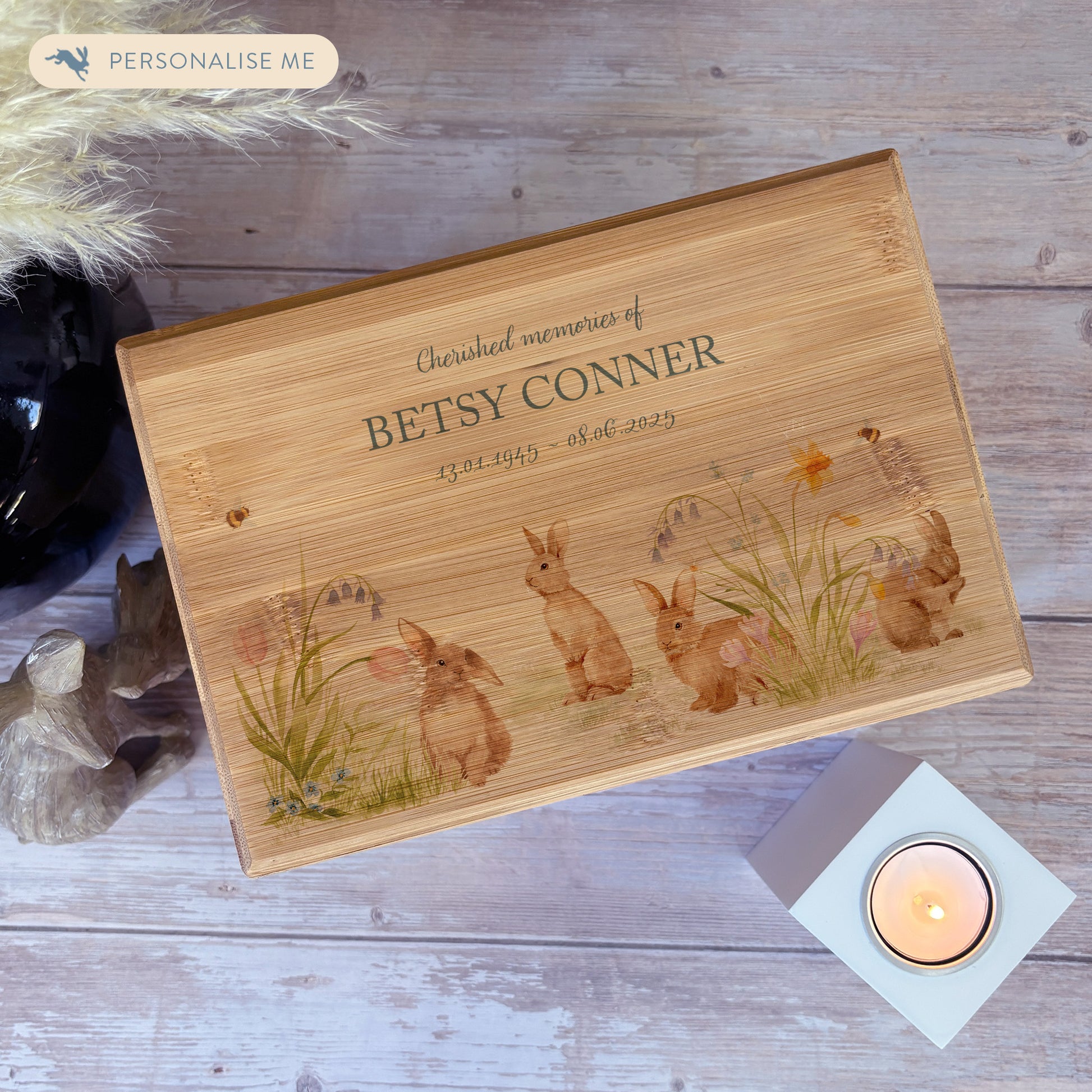 A beautifully crafted solid Bamboo wooden urn, finished with a soft watercolour design of bunnies in a spring flower meadow, Thoughtfully made for either display or burial, this personalised urn can be customised to create a meaningful memorial. Perfect for holding ashes of a loved one or a beloved pet, it serves as a comforting tribute and keepsake. 