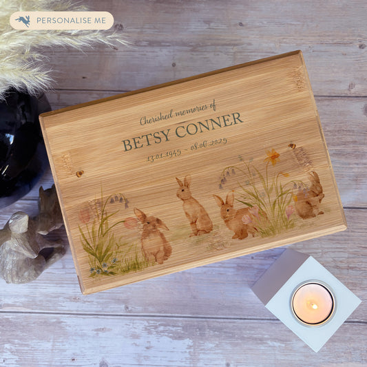 A beautifully crafted solid Bamboo wooden urn, finished with a soft watercolour design of bunnies in a spring flower meadow, Thoughtfully made for either display or burial, this personalised urn can be customised to create a meaningful memorial. Perfect for holding ashes of a loved one or a beloved pet, it serves as a comforting tribute and keepsake. 