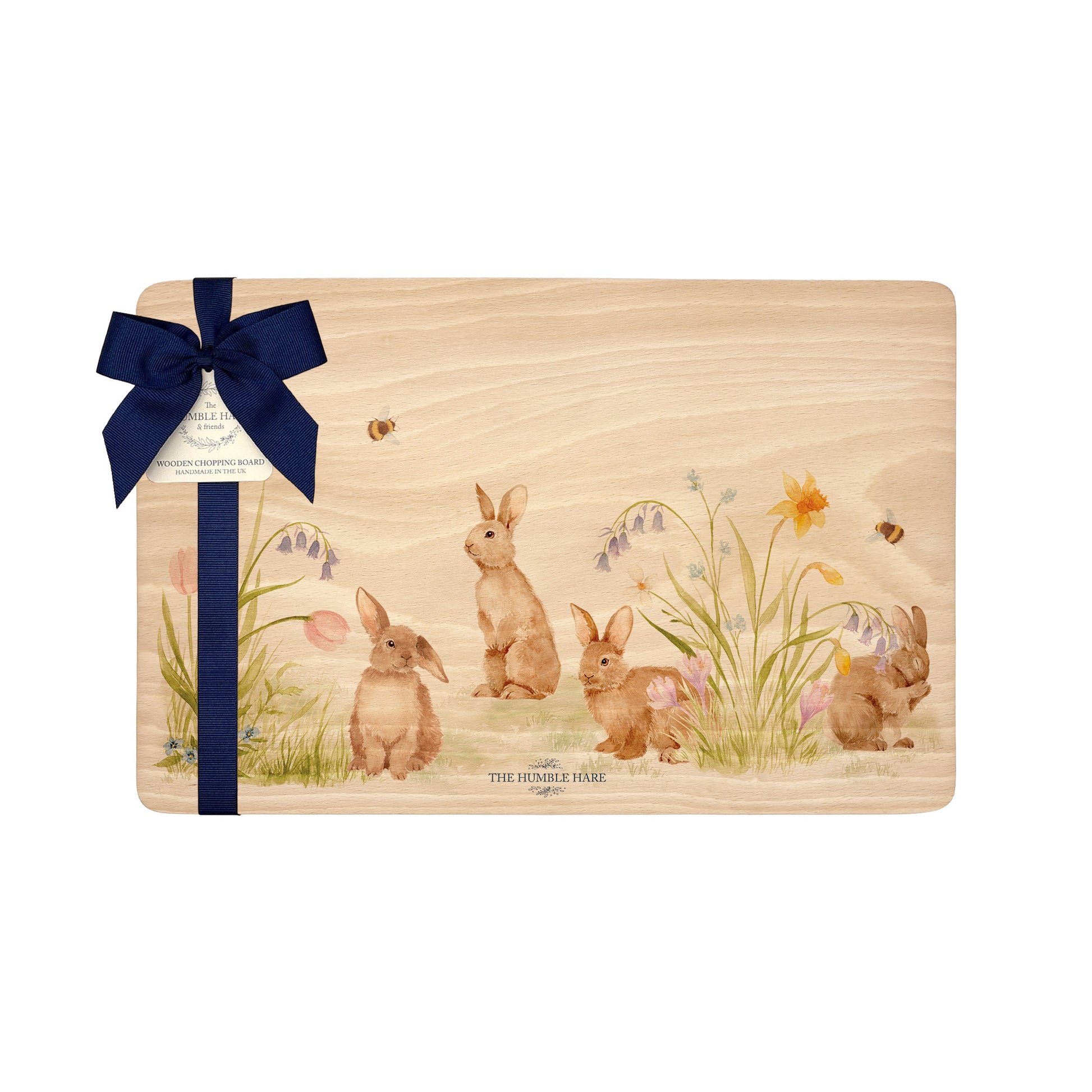 Rectangle beech wood chopping board featuring our blooming bunnies woodland animal design, with rabbits among spring flowers. The wooden board is finished with a blue gift ribbon and tag.