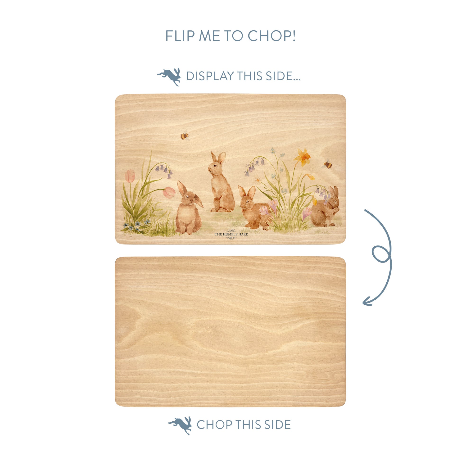 Wooden cutting board with a bunnies and flowers illustration on one side and plain wood on the other, with text indicating which side to display and which to chop.