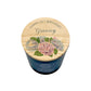 A birthday candle in a dark blue glass jar with a light wood lid  personalised with 'HAPPY 70TH BIRTHDAY Granny' and decorated with pink and blue hydrangeas.