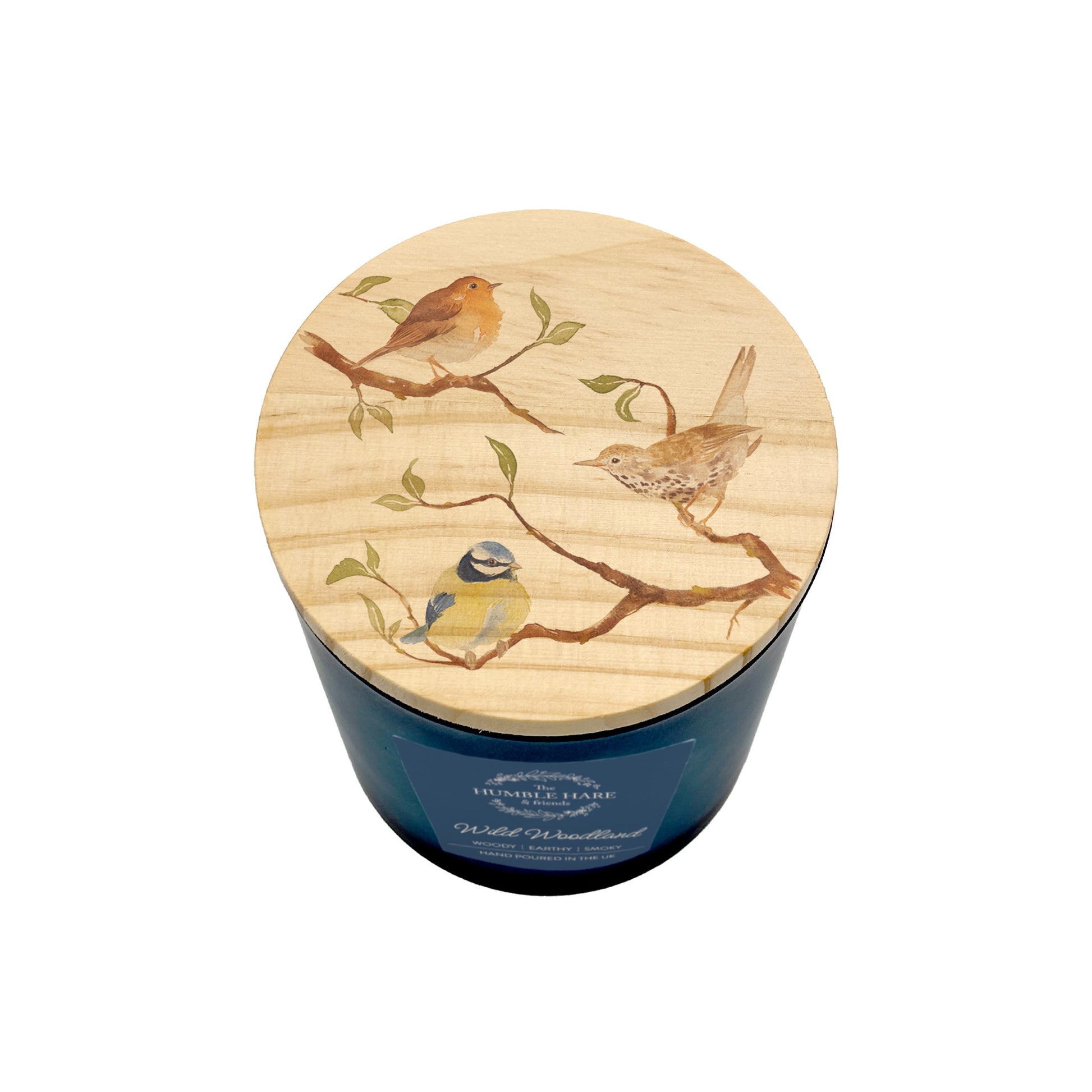 A blue glass jar candle with a round light wood lid decorated with painted birds perched on branches, shown on a plain white background.
