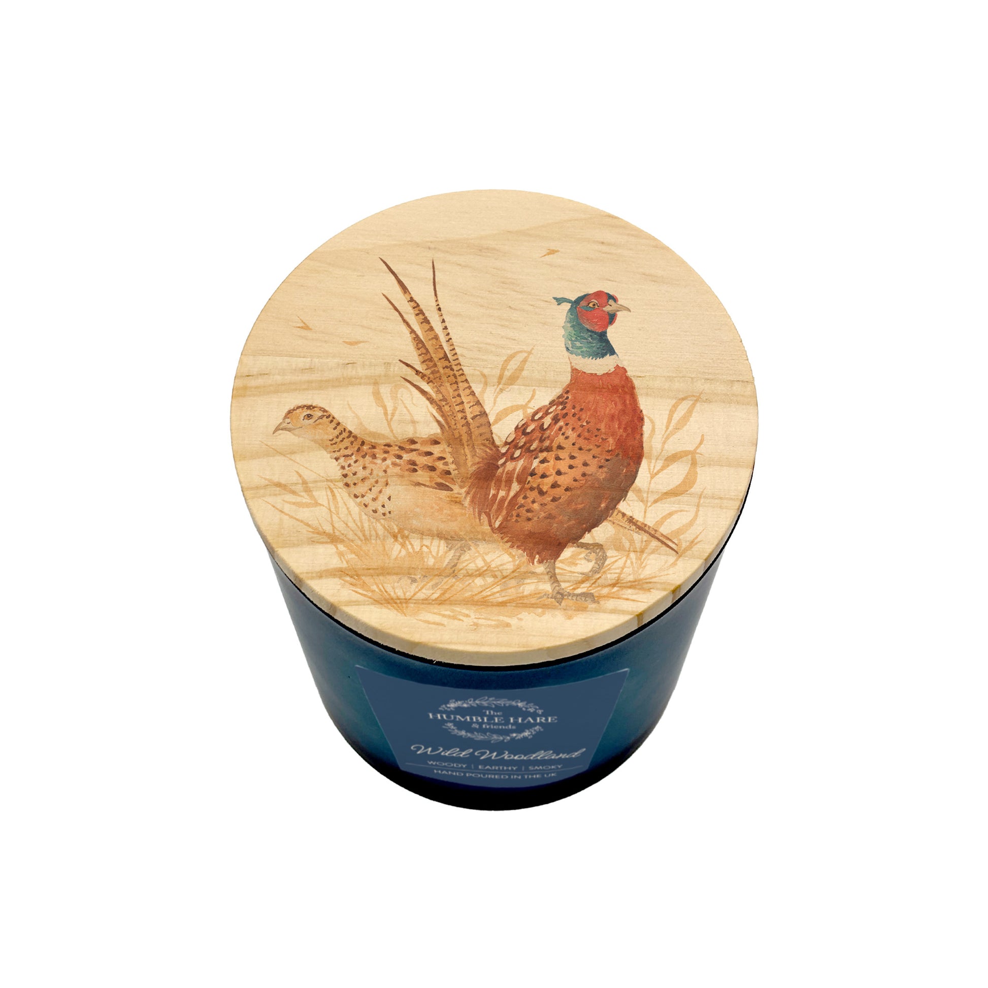 A blue glass jar candle with a round light wood lid featuring a detailed illustration of two pheasant birds in a grassy field, shown on a white background.
