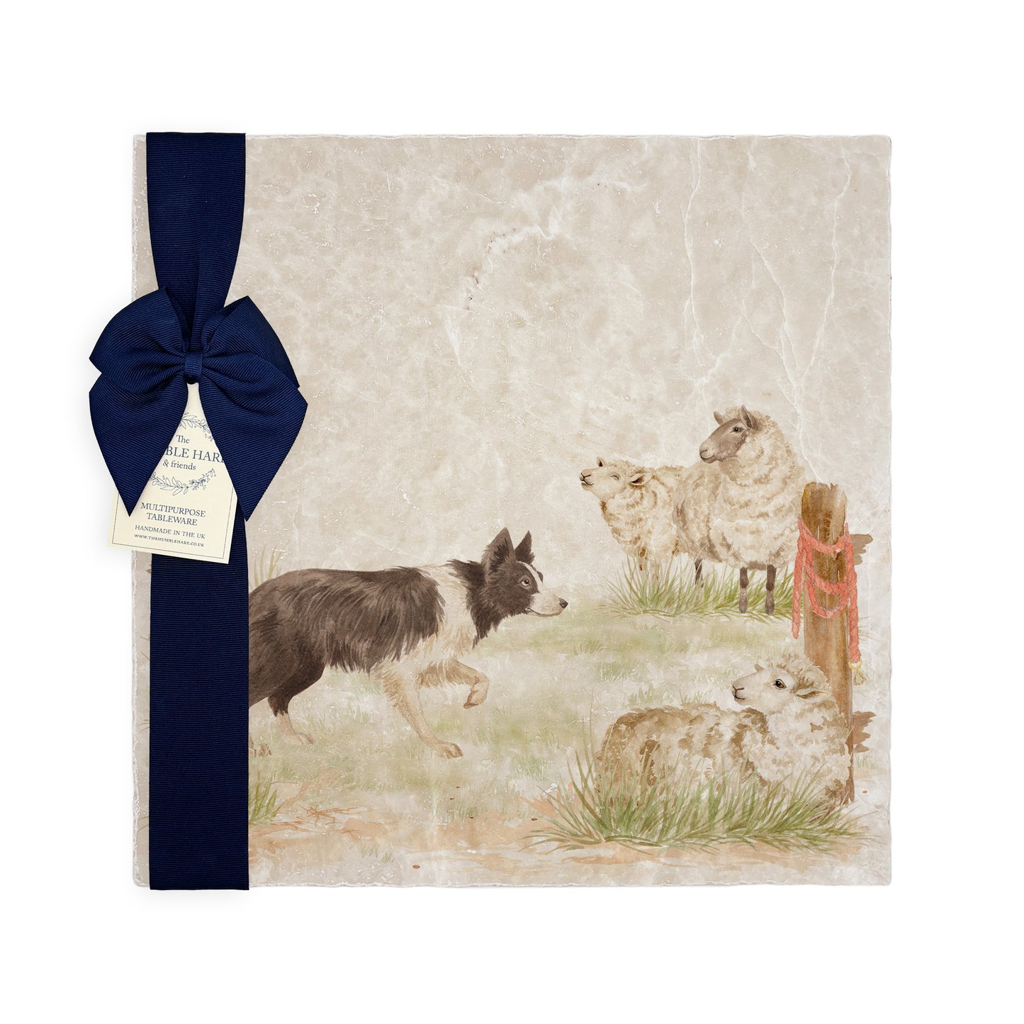 A square large marble platter with a design of a border collie working dog herding sheep through a gate on the farm. The platter is packaged with a luxurious blue ribbon and gift bow.