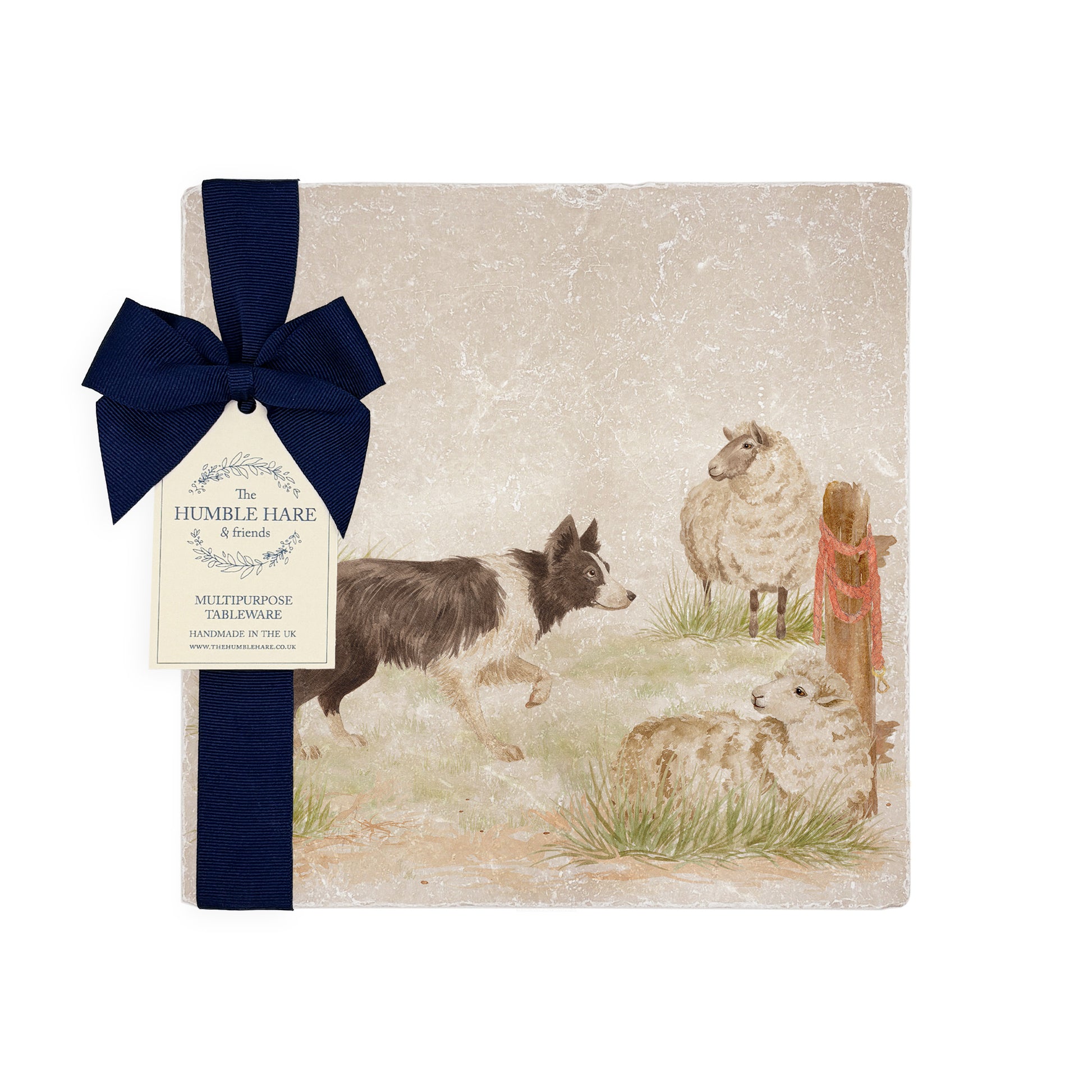 A square medium marble platter with a design of a border collie working dog herding sheep through a gate on the farm. The platter is packaged with a luxurious blue gift bow.