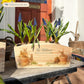 An arched wooden planter box full of spring bulbs. The planter box shows a watercolour design of cute bunny rabbits in plant pots, eating the flowers. The planter can be personalised with names and a selection of phrases to suit any occasion, including wedding, anniversary, engagement, birthday and new home.