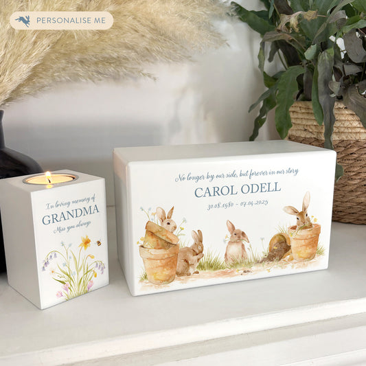 Luxury solid wooden white painted Urn ,  Featuring Bunnies on pots , A watercolour illustration, our urns and Caskets for displaying or burying ashes. Customisable and can be personalised. Perfect funeral memory keepsake urn, for storing ashes for humans and pets. 