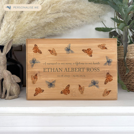 A beautifully crafted solid Bamboo wooden urn, personalised and finished with a soft watercolour design of flying Butterflies, Thoughtfully made for either display or burial, this personalised urn can be customised to create a meaningful memorial. Perfect for holding ashes of a loved one or a beloved pet, it serves as a comforting tribute and keepsake. 