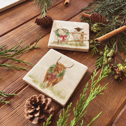 A set of mix and match marble coasters featuring different Christmas designs including sheep and highland cows wearing Christmas wreaths.