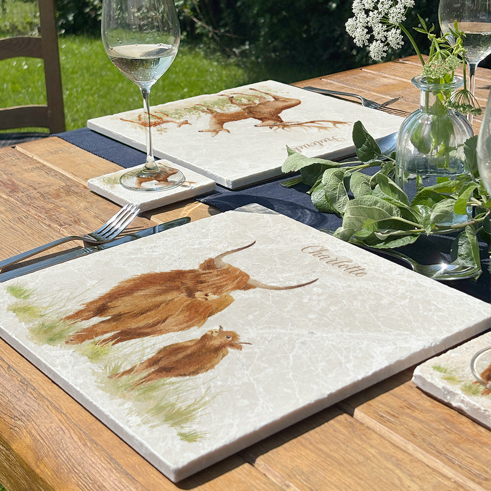 A beautiful garden table set with personalised marble placemats and coasters, ready for a dinner party.