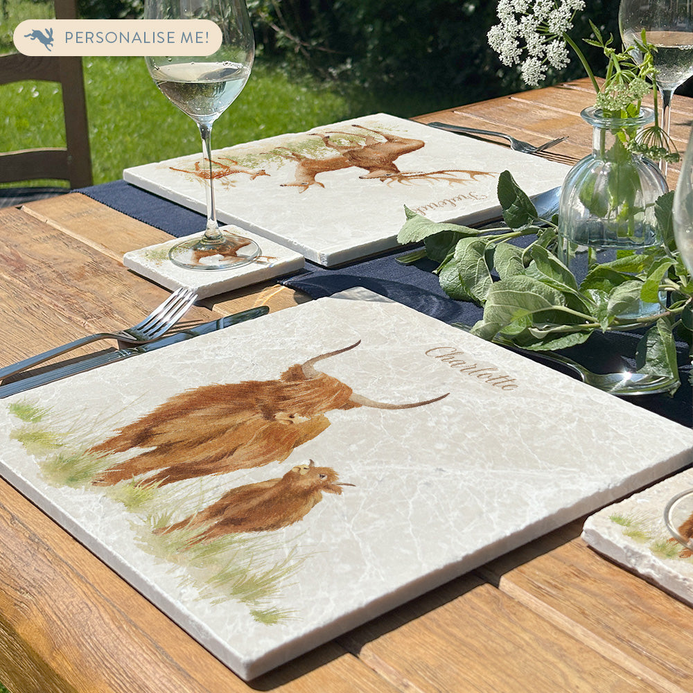 A beautiful garden table set with personalised marble placemats and coasters, ready for a dinner party. The placemats feature countryside animals with personalised names above them.