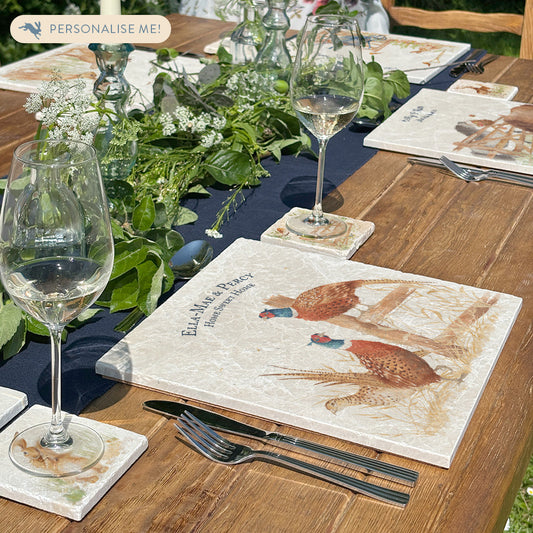 A beautiful garden table set with personalised marble placemats and coasters, ready for a dinner party.