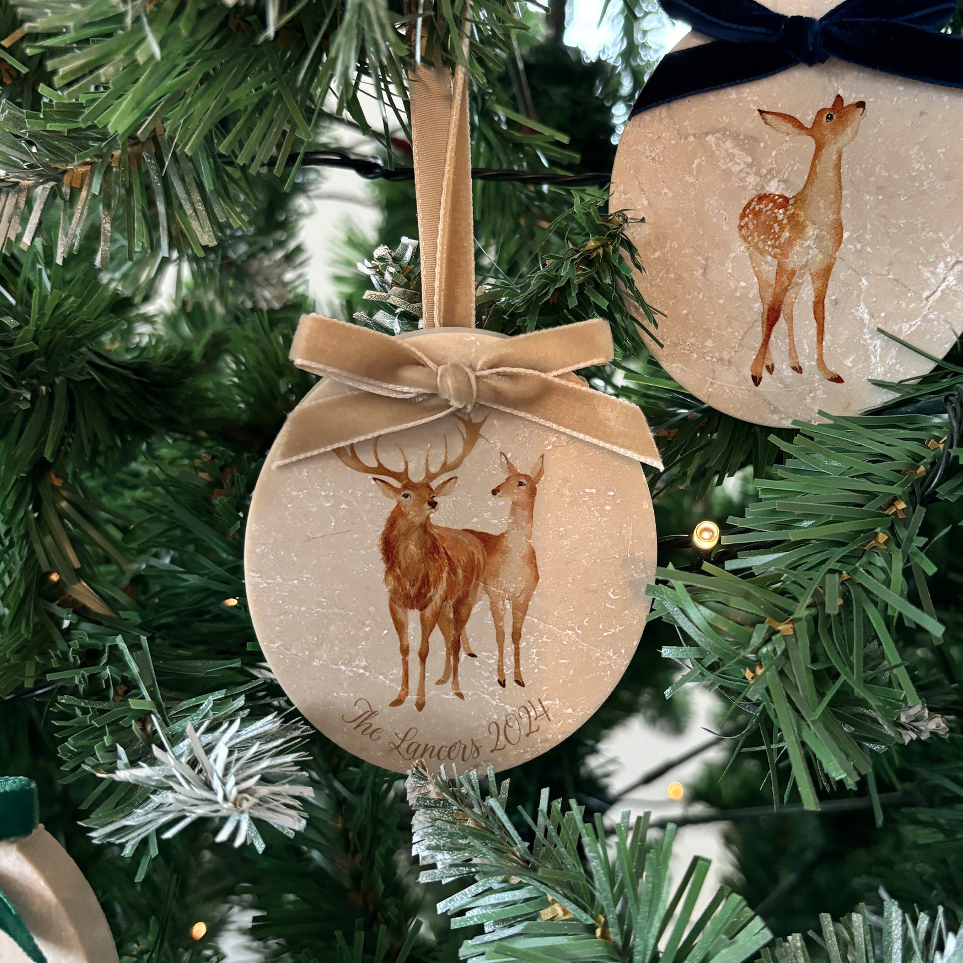 Transform your Christmas tree with our unique oval-shaped marble baubles, showcasing stunning watercolour artwork of a stag, doe and fawn. Personalise each bauble to make it truly your own, and choose from a variety of velvet ribbon colours to suit your holiday décor.