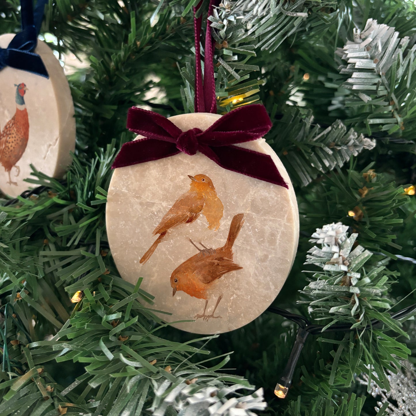 Create a timeless look for your Christmas tree with our oval-shaped marble baubles. Decorated with stunning watercolour artwork and finished with a velvet ribbon in your choice of colour, these baubles can be personalised to add a personal touch to your festive décor.