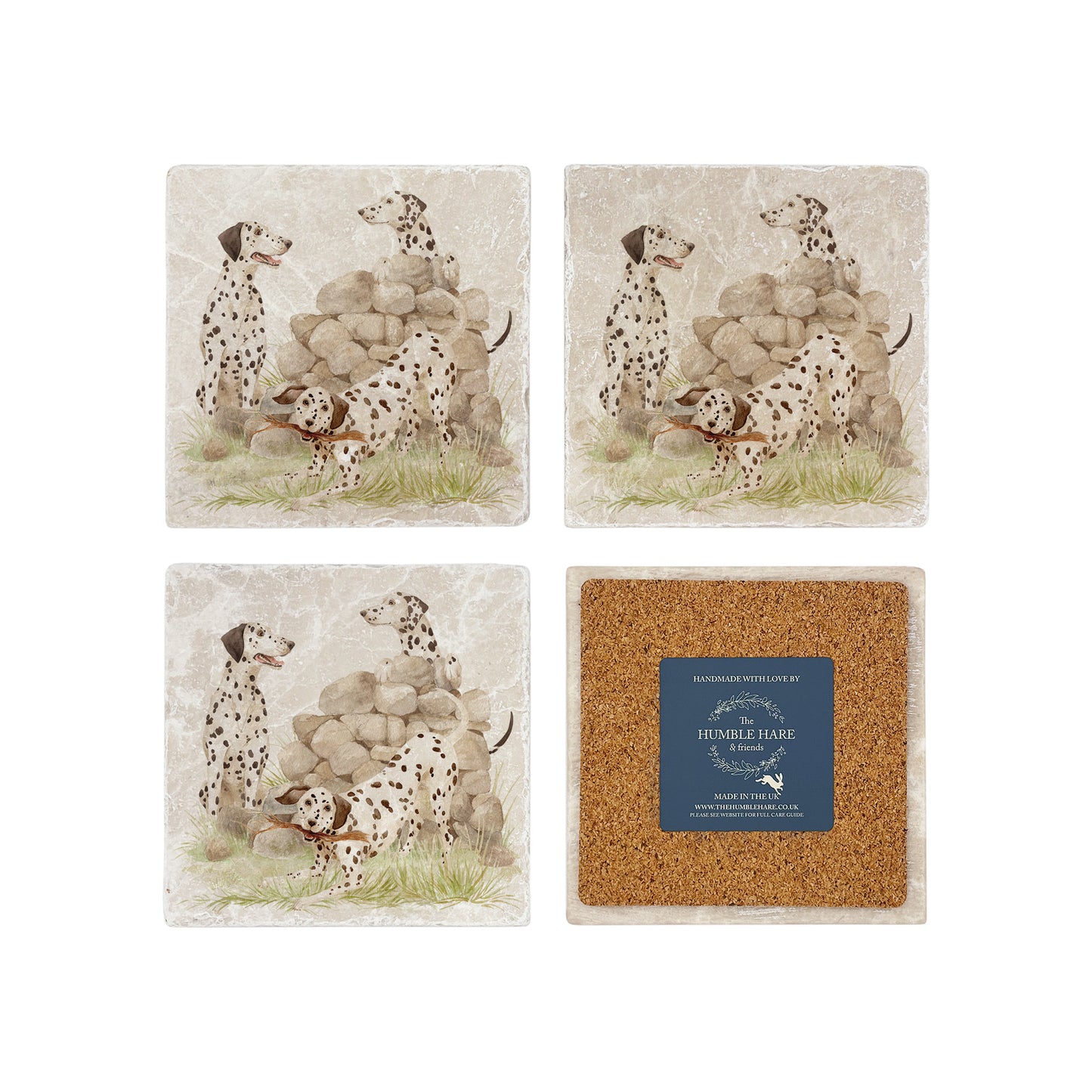 A set of 4 marble coasters with dalmatian dogs playing next to an old stone wall in the countryside. One coaster is flipped to show that it's backed with cork to protect work surfaces.
