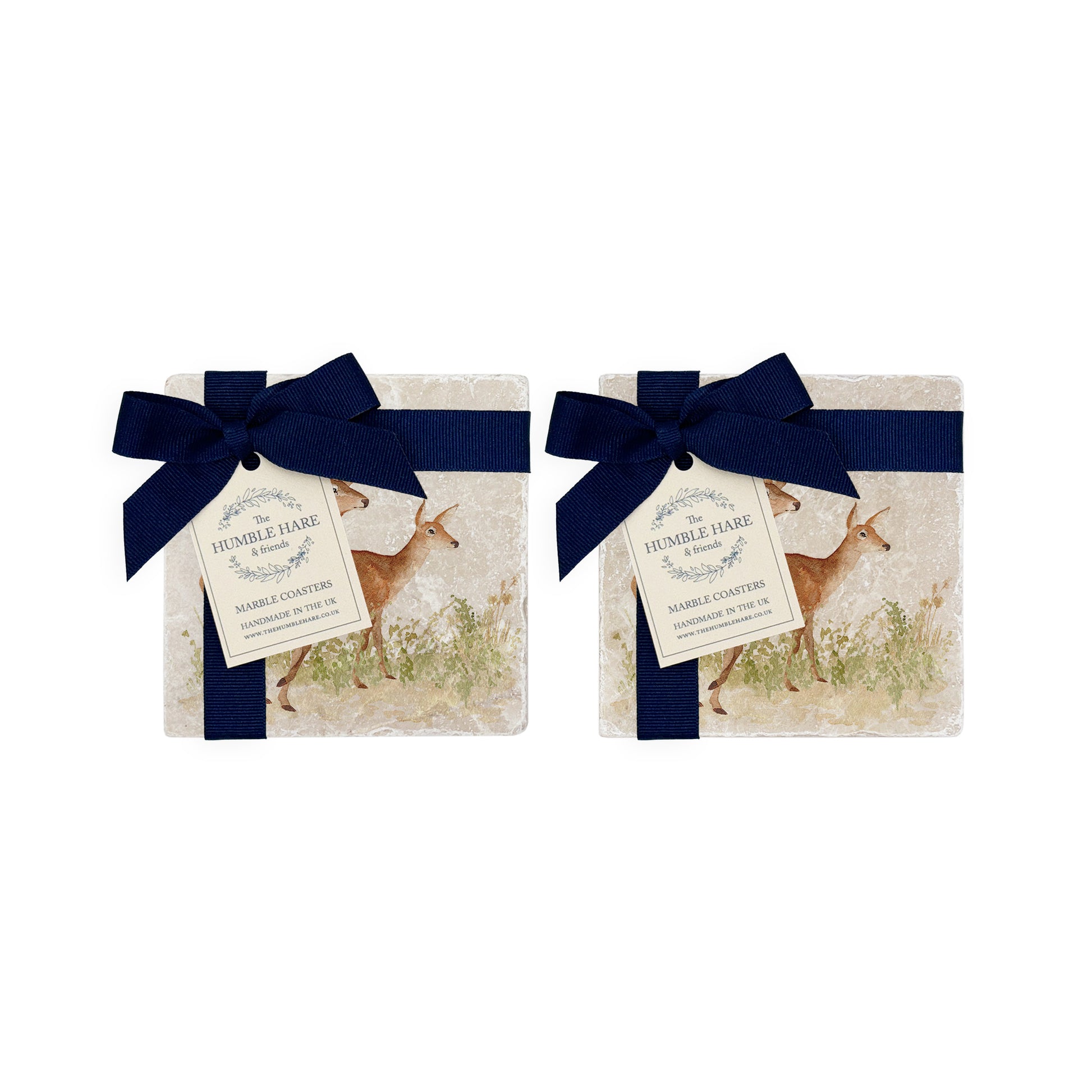 A set of 4 handmade marble coasters packaged in 2 pairs, with a luxurious blue bow and gift tag. The coasters feature a watercolour design of a red deer stag and hind.