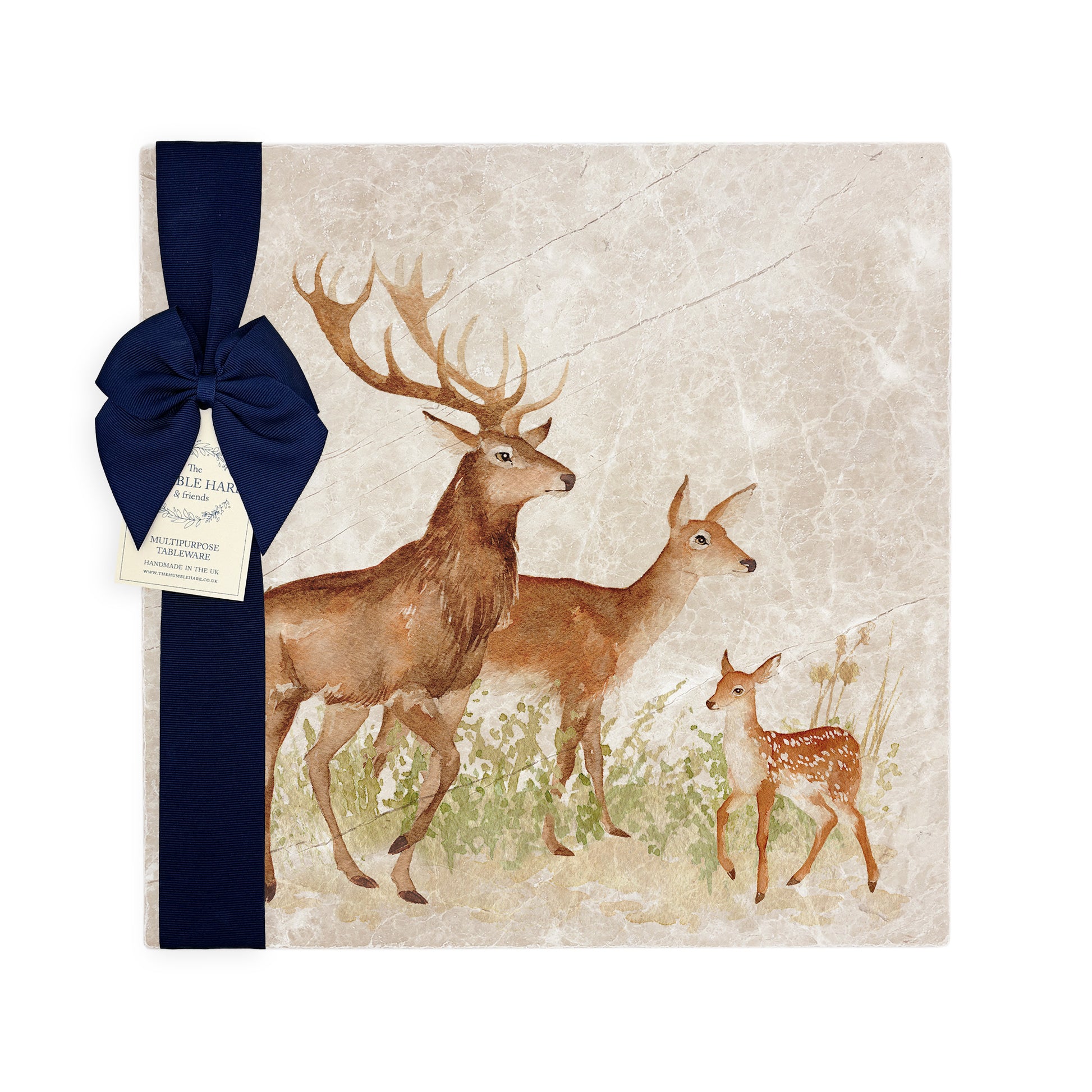 A multipurpose marble platter with a watercolour design featuring a family of red deer, packaged with a luxurious dark blue bow and branded gift tag.