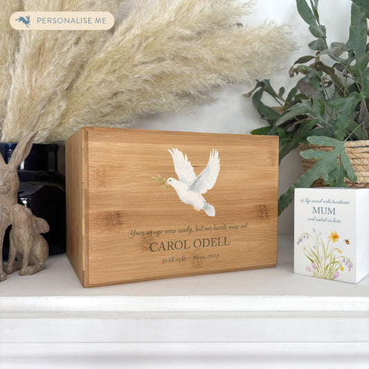 A beautifully crafted solid Bamboo wooden urn, personalised and finished with a soft watercolour design of a flying Dove, Thoughtfully made for either display or burial, this personalised urn can be customised to create a meaningful memorial. Perfect for holding ashes of a loved one or a beloved pet, it serves as a comforting tribute and keepsake. 