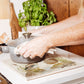 A large square marble platter being used as a trivet for a hot pan. The trivet features a watercolour design of two mallard ducks standing at the edge of a pond.