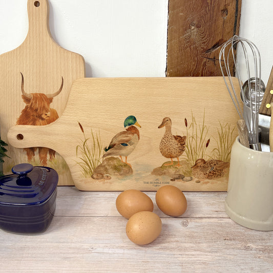 Handmade paddle board in Beech wood, featuring a painted mallard Ducks with a hand tied luxury blue ribbon. 