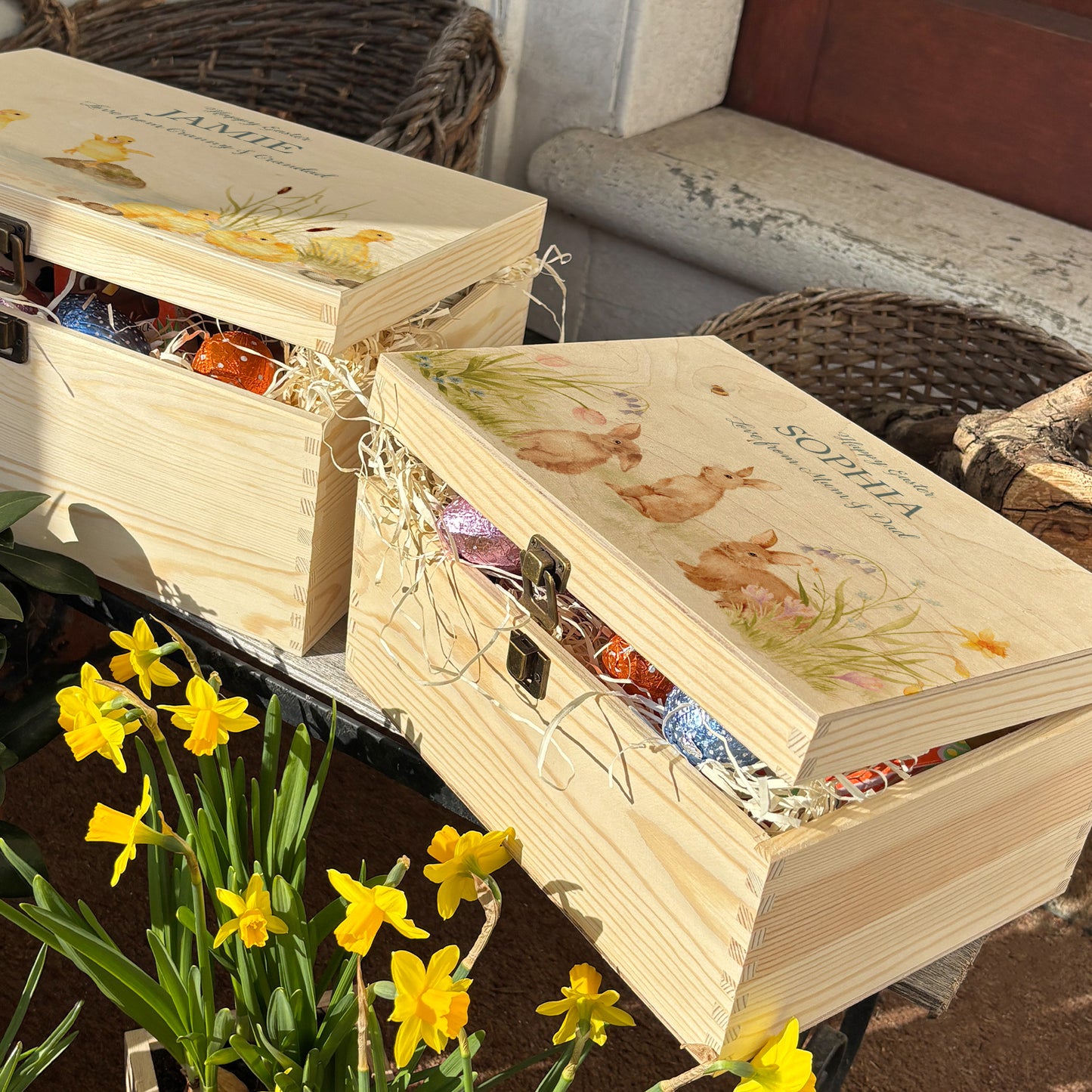 Small Easter personalised wooden pine box, perfect for Easter treats, eggs, gifting. Children gifts. This box has a beautiful easter theme with 3 bunnies surrounded by some spring flowers and some bees. This box can be personalised in 4 phrases or it can just have the design and no text. What better way to surprise your friend, parent, teacher or child with a unique personalised keepsake easter box. This box shows a great example of how to fill your easter box with treats 